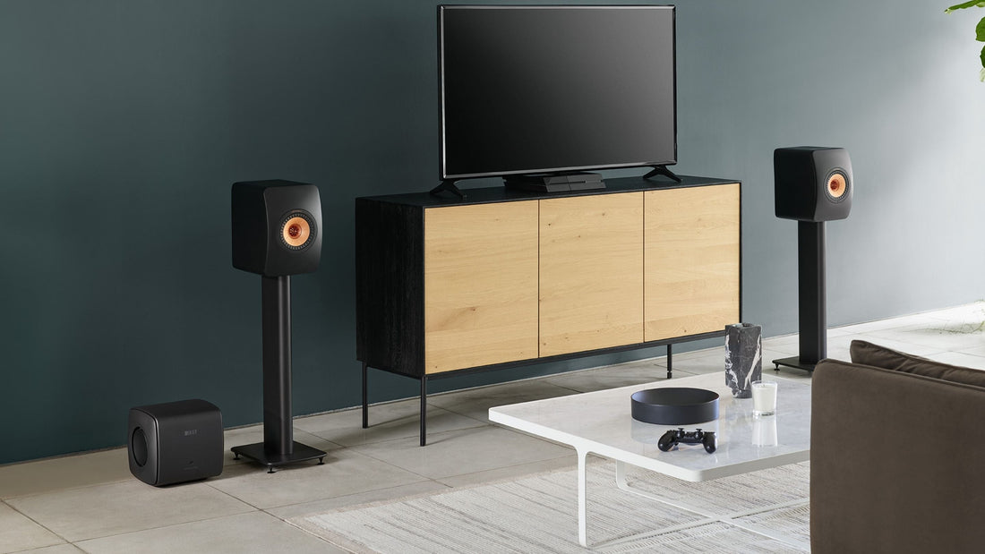 KEF KC62 subwoofer placed next to a LS50 Wireless II speaker in a living room