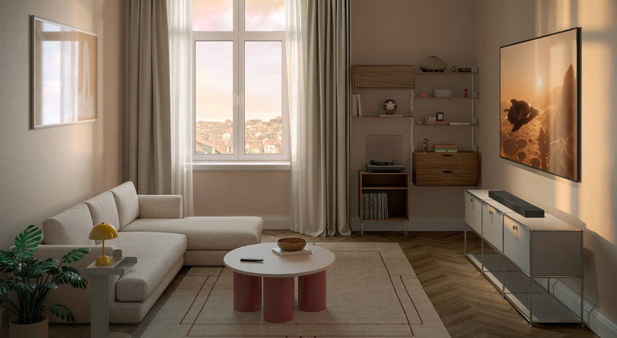 Modern living room with wall-mounted TV, beige corner sofa, soft natural lighting and minimalist decor in neutral tones