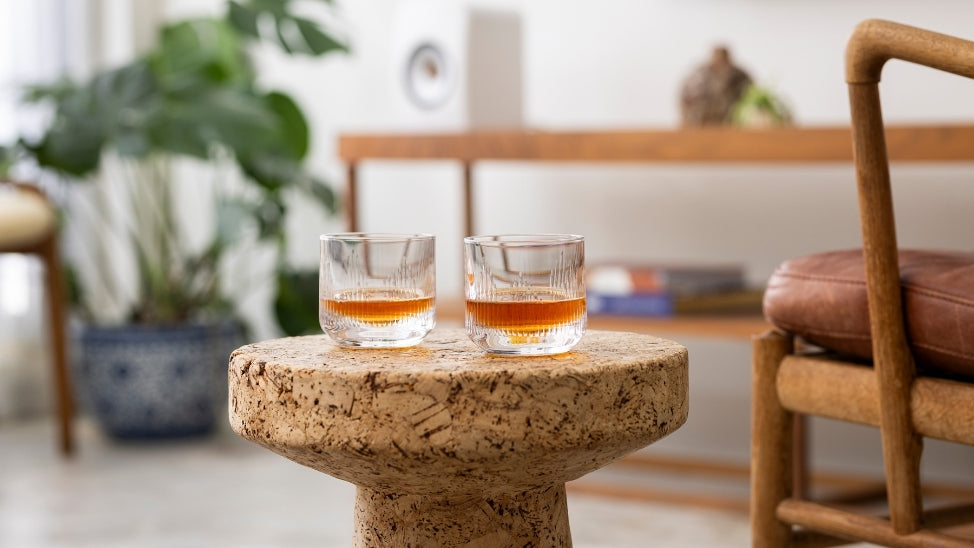 KEF whiskey glasses on side table in living room.