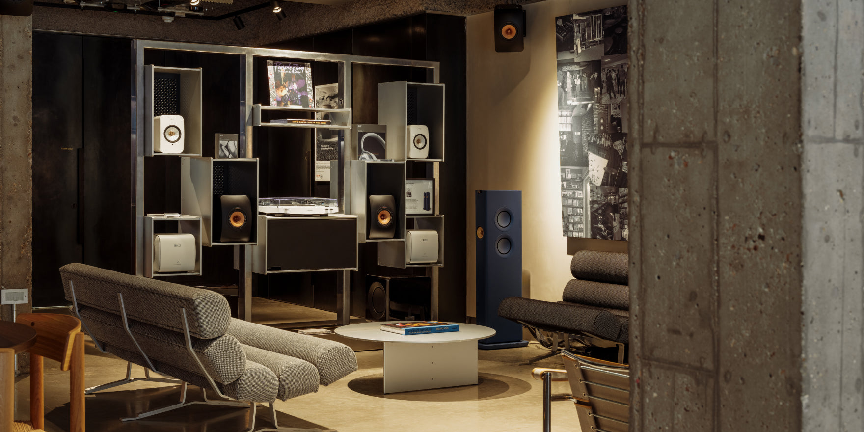 Modern home theater setup with multiple speakers and a cozy living room at KMG London.